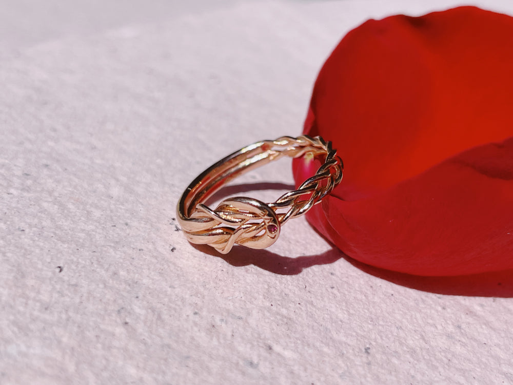 
                  
                    "Love" Knot Ring with a Ruby
                  
                