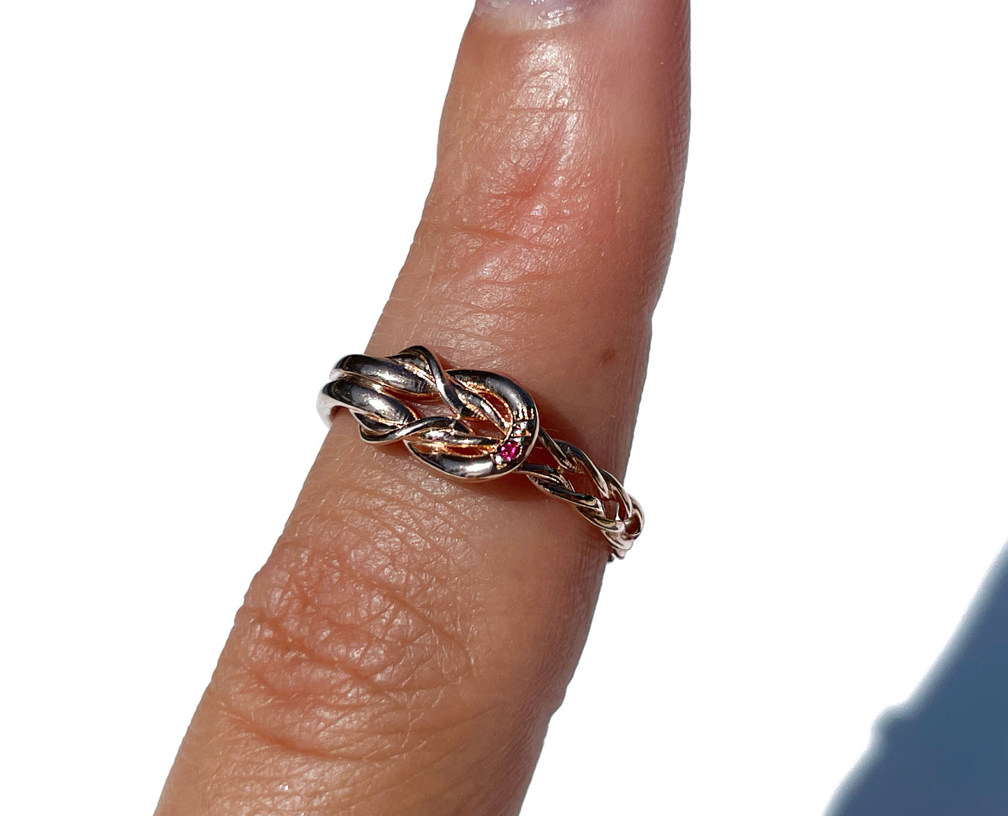 
                  
                    "Love" Knot Ring with a Ruby
                  
                